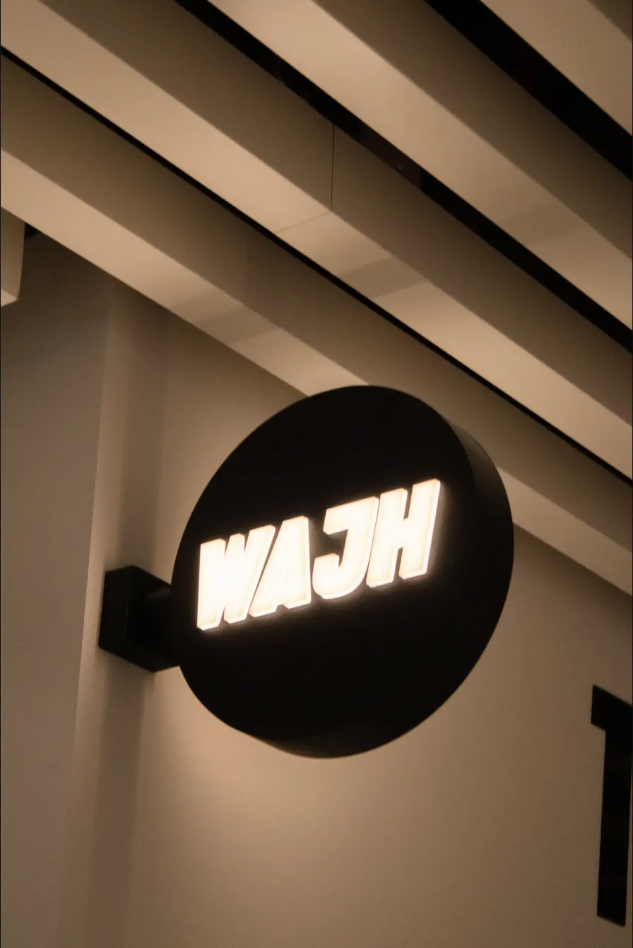Illuminated WAJH sign outside the studio
